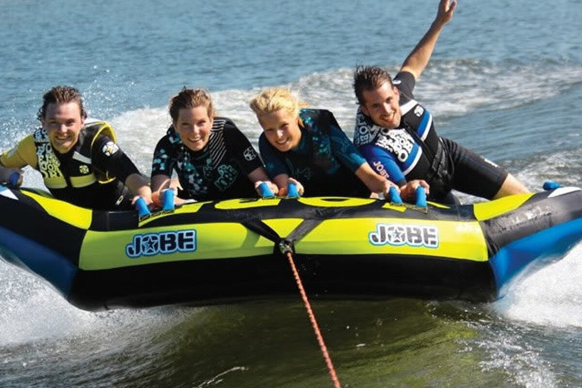 a family on a pull along buoy