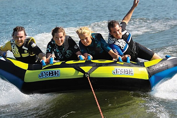 a family on a pull along buoy