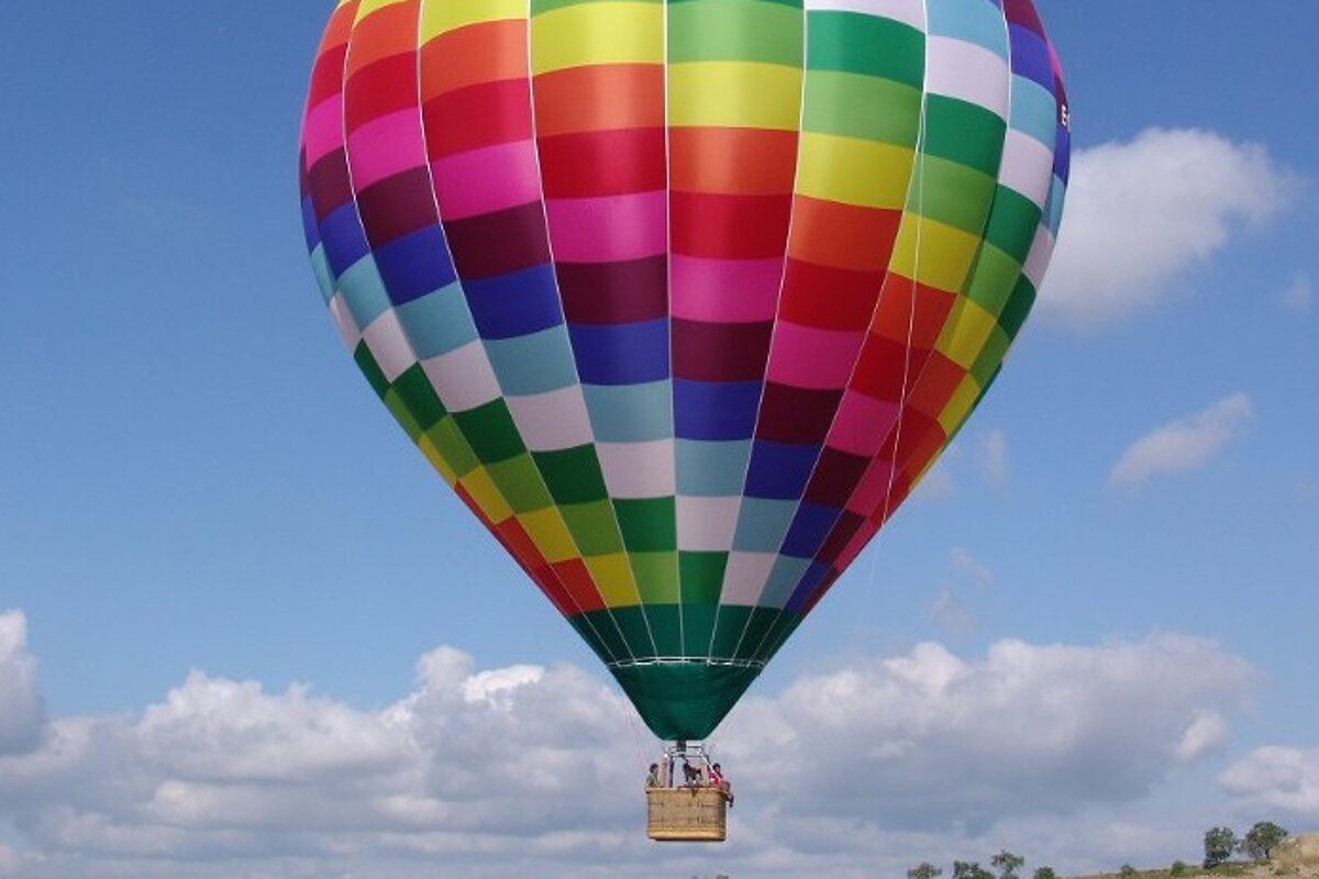 A colorful hot air balloon is flying in the sky