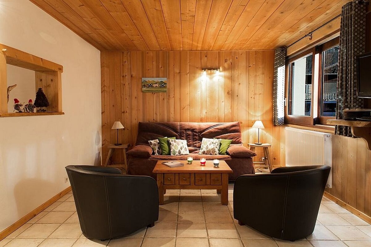 A living room with a couch and two chairs