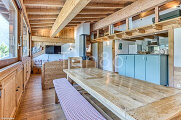 A wooden table with a bench in a room with a sign that says tango