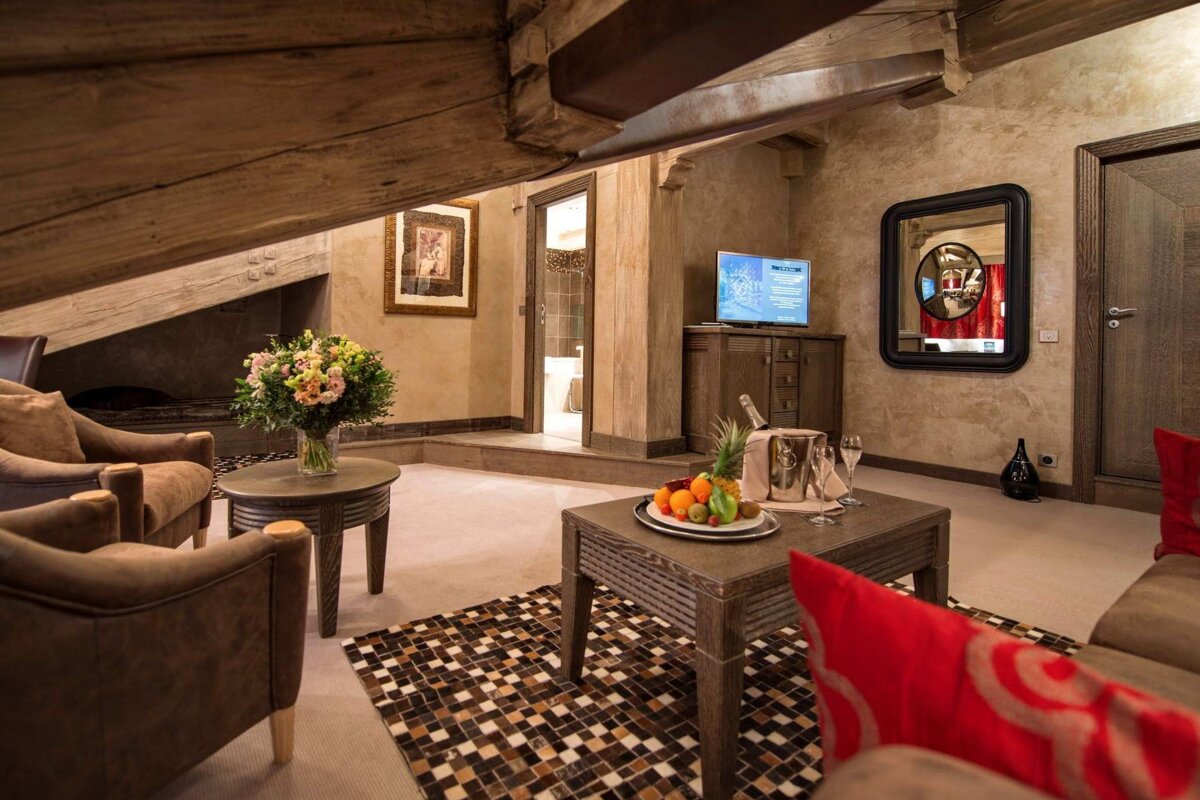 A living room with a tv and a bottle of champagne