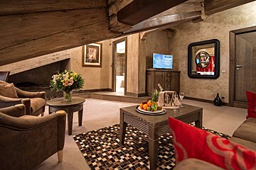 A living room with a tv and a bottle of champagne