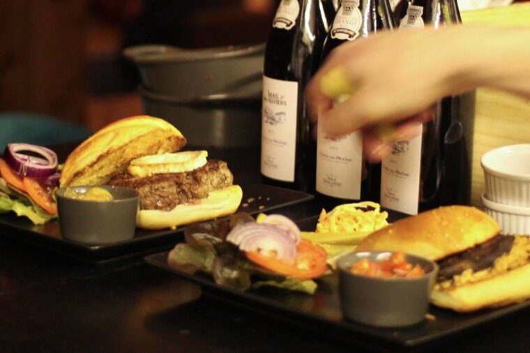 two plates of burgers