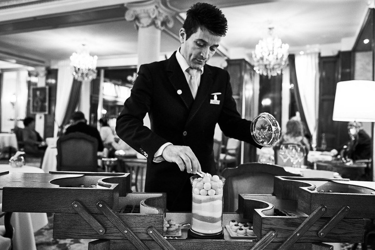 waiter with pastry trolley in nice restaurant in nice