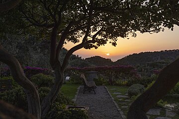 A sunset with a bench in the foreground