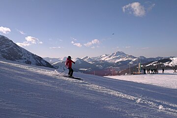 Photo of man skiing with mountains in background