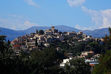 a town on a hilltop with a tower at the top