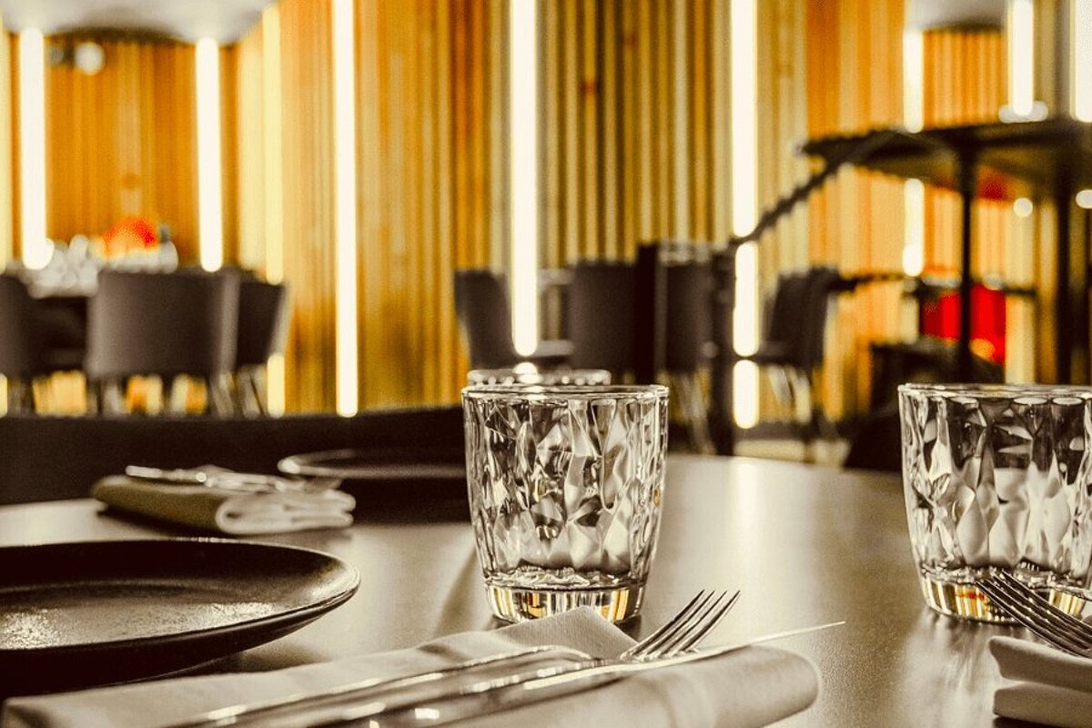 A table with plates and glasses on it in a restaurant