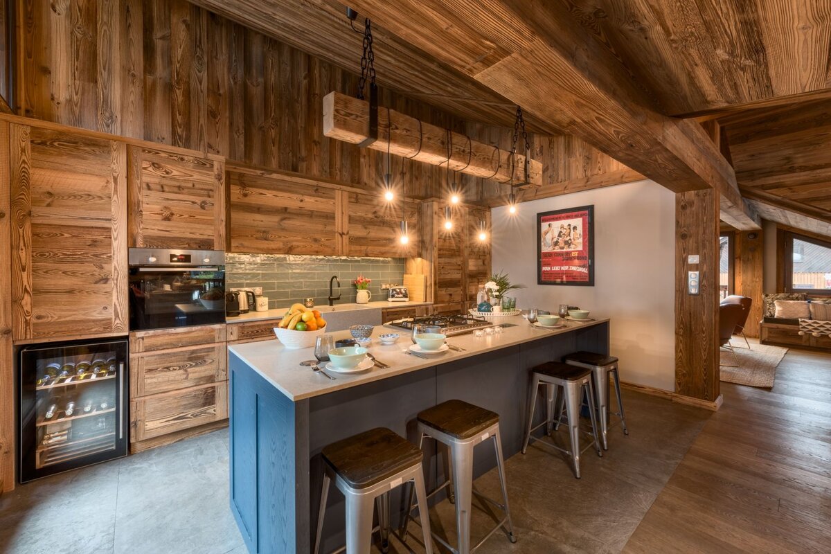 A kitchen with wooden cabinets and a sign on the wall that says 