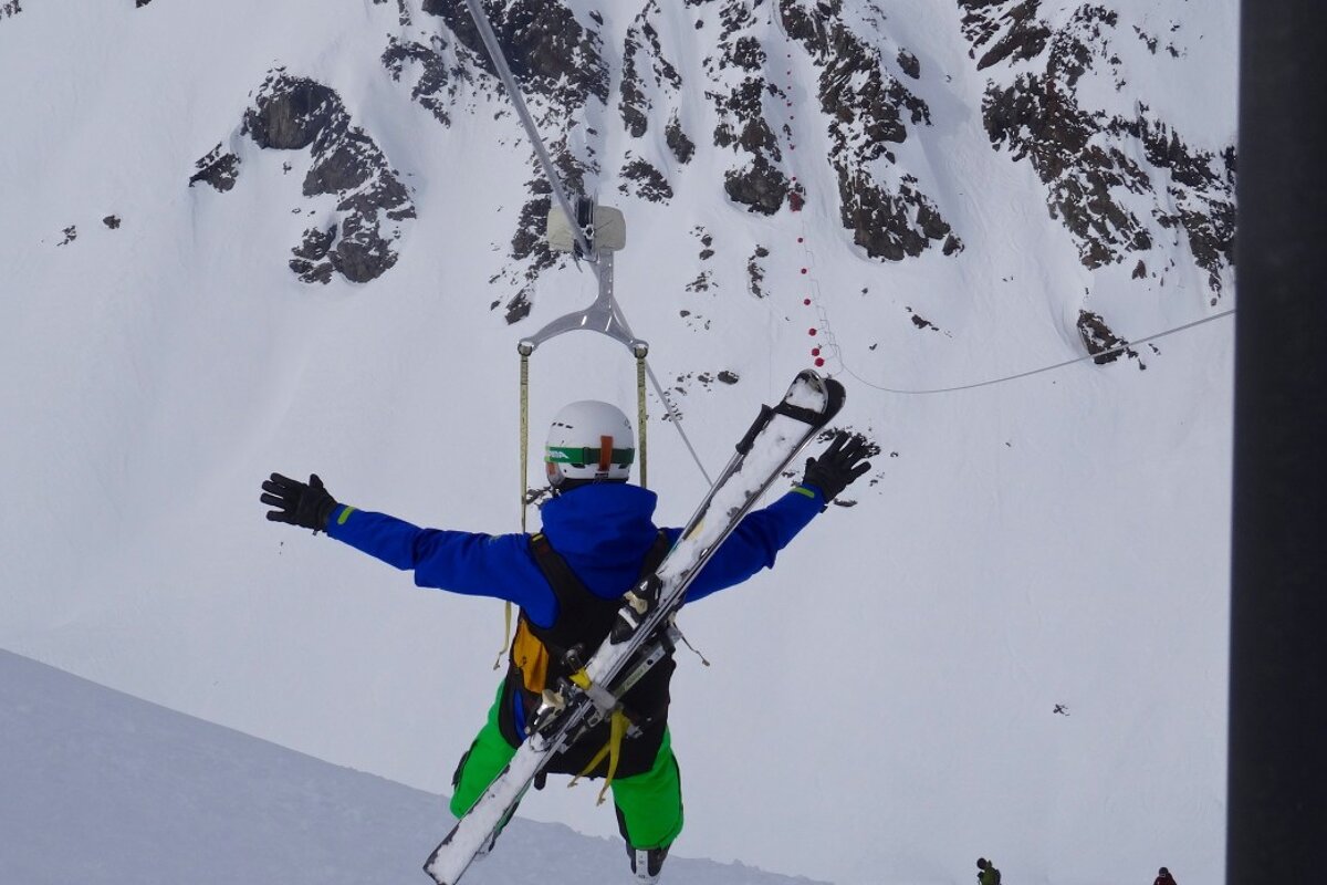 a skier with arms out wide 