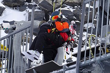 a boy grabbing on to a zip wire harness