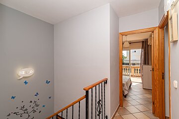 A hallway with a sign on the wall that says hello