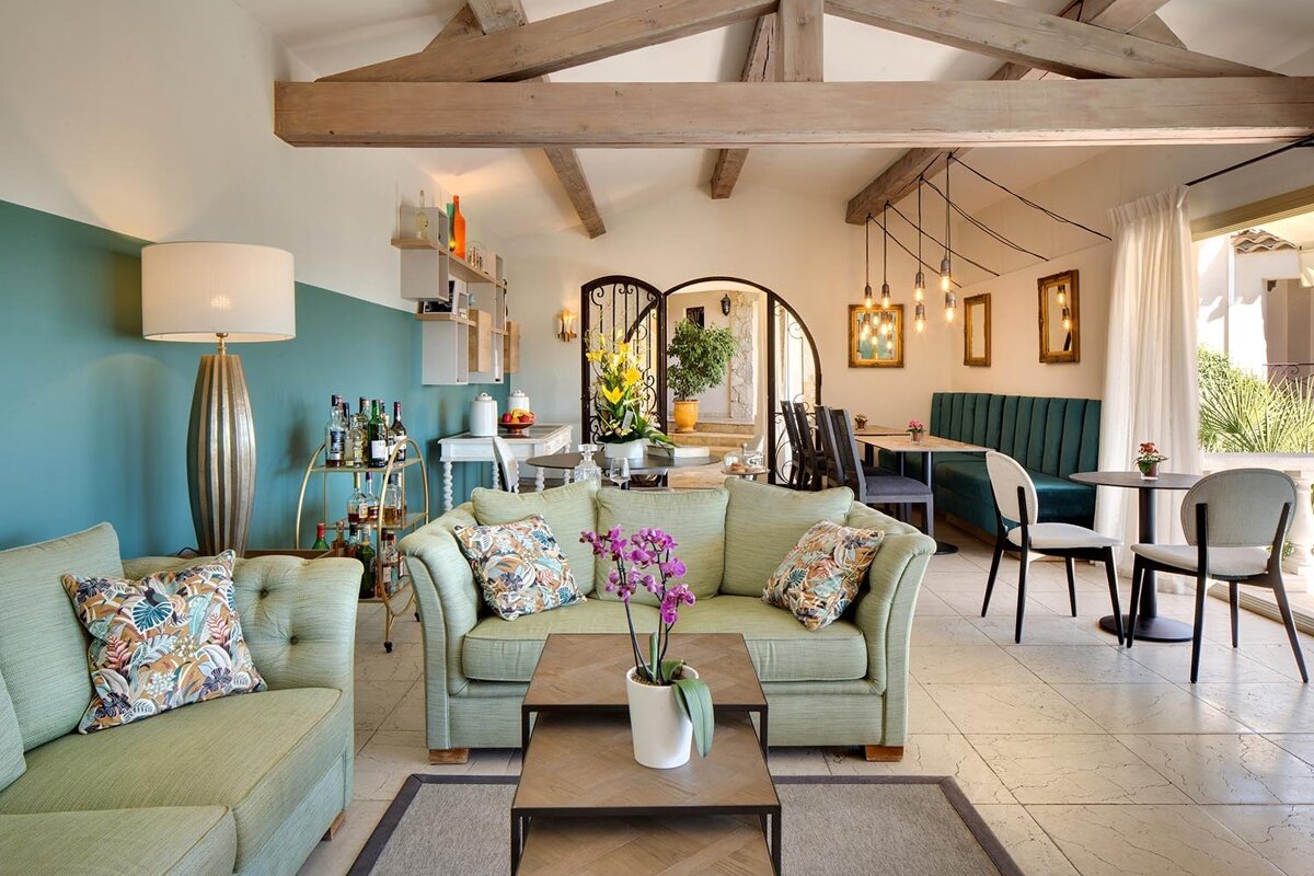 A living room with a green couch and a table