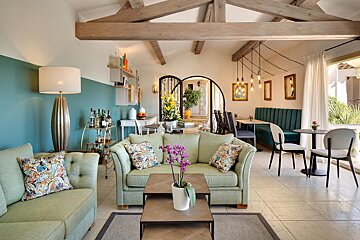 A living room with a green couch and a table