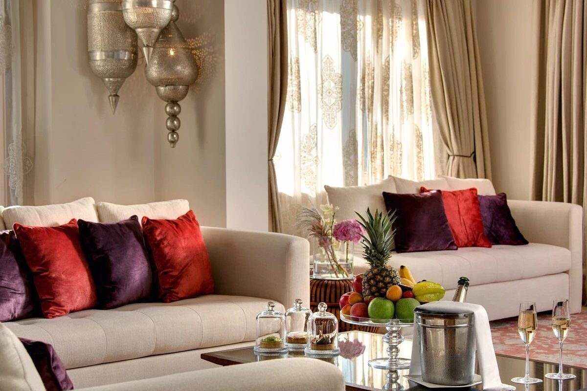 A living room with a couch and a table with fruit on it