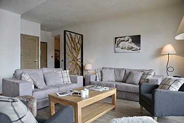 A living room with a couch a chair and a coffee table
