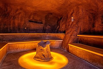 A room with a large rock in the middle of it