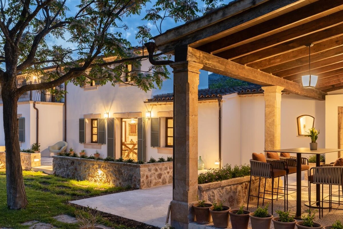 A house with a covered porch with a table and chairs