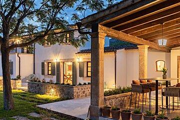 A house with a covered porch with a table and chairs