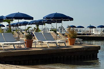 A row of chairs and umbrellas on a beach