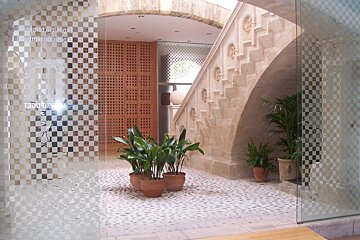A building with a staircase and a sign that says ' gourmet ' on it