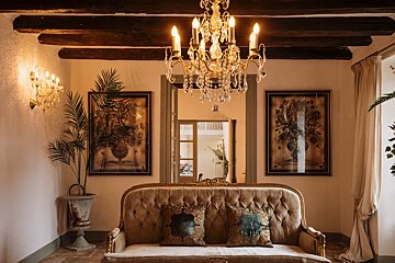 A living room with a couch and a chandelier