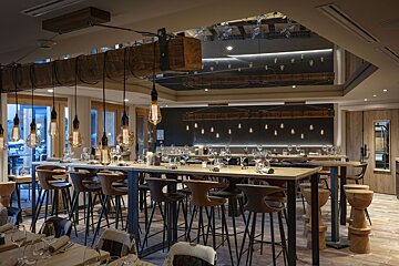 A restaurant with a lot of tables and chairs