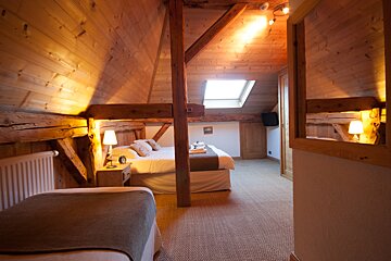 A bedroom with a bed and a mirror on the wall