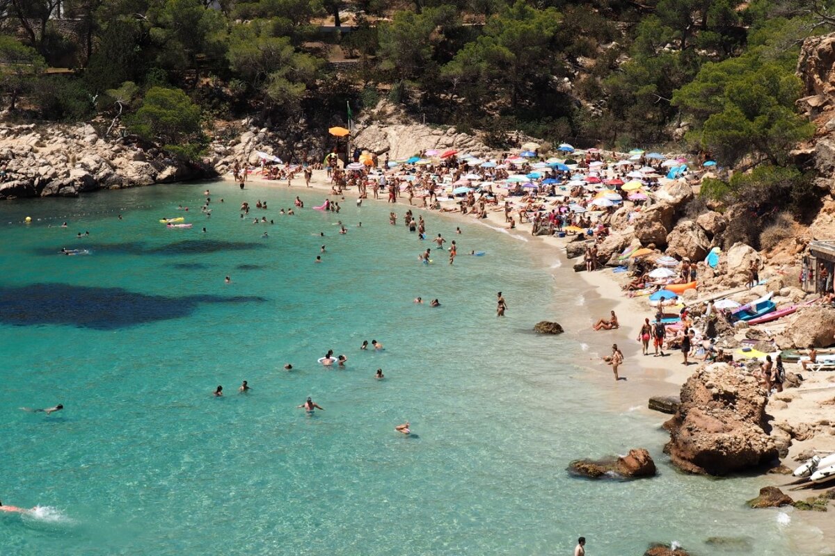 a view down to the beach of cala salada in ibiza