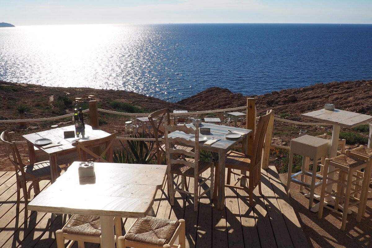 tables on a clifftop terrace on west coast ibiza