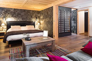 A bedroom with a bed and a coffee table