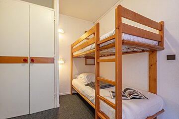 A bunk bed with a magazine on the bed