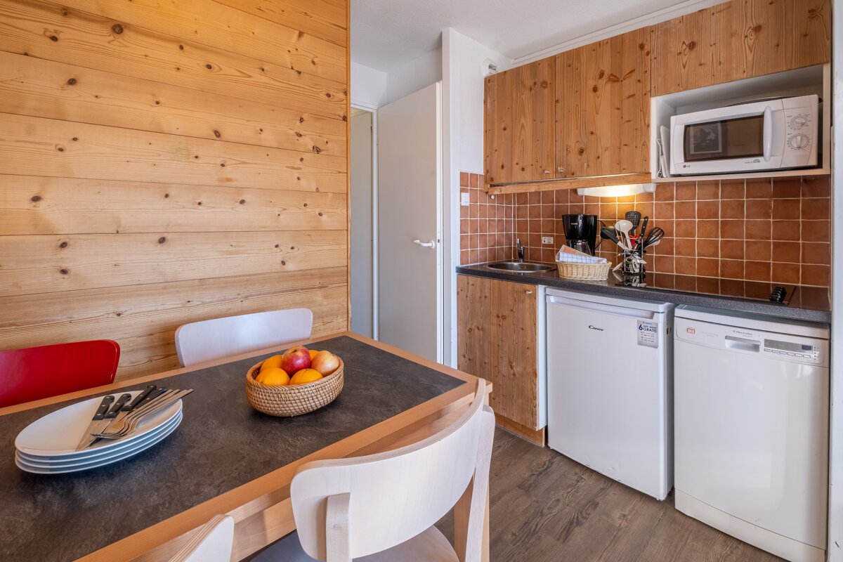 A small kitchen with a candy brand refrigerator