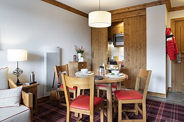 A living room with a dining table and chairs