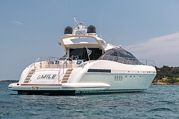 A large white yacht with the name smile on the back