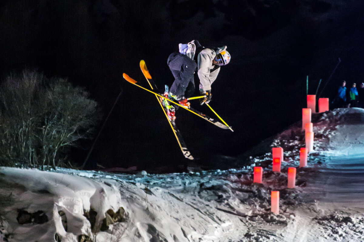a skier doing a trick in a night competition