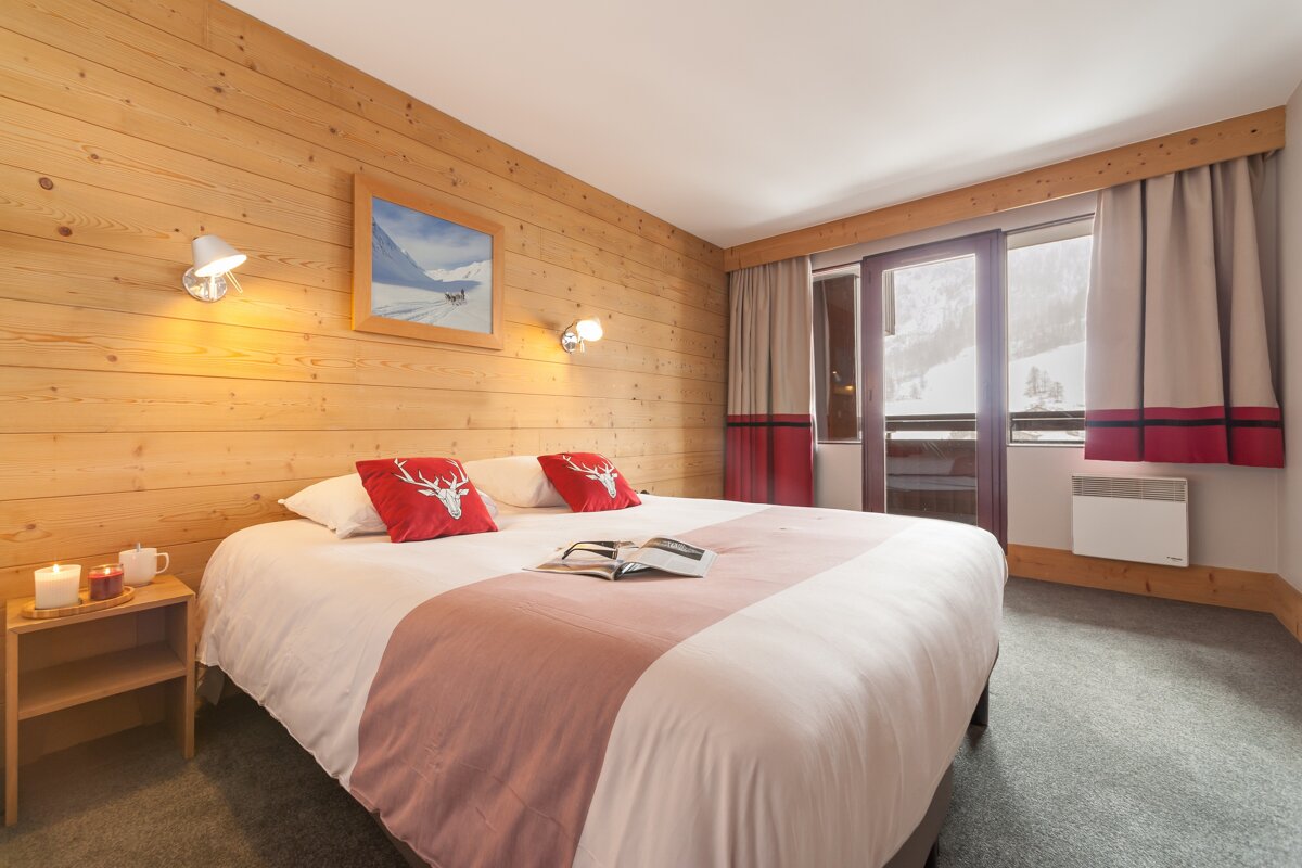 A bedroom with a bed and a book on it