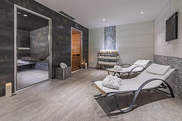 A room with two lounge chairs and a sauna