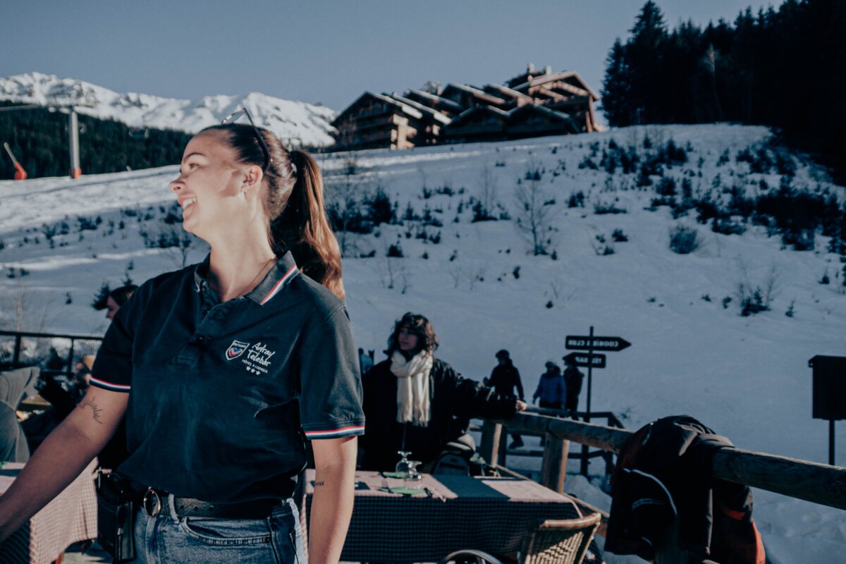 A woman wearing a polo shirt that says alpine valley