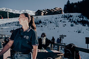 A woman wearing a polo shirt that says alpine valley