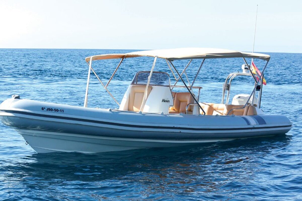 A boat with a canopy on top of it is floating in the ocean