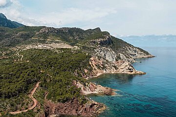 An aerial view of a cliff overlooking a body of water