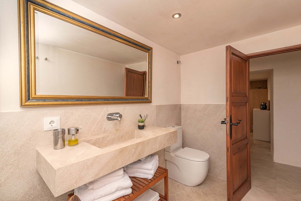 A bathroom with a large mirror and a sink
