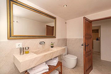 A bathroom with a large mirror and a sink
