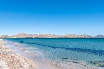 A large body of water with mountains in the background