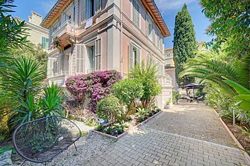A house with purple flowers in front of it