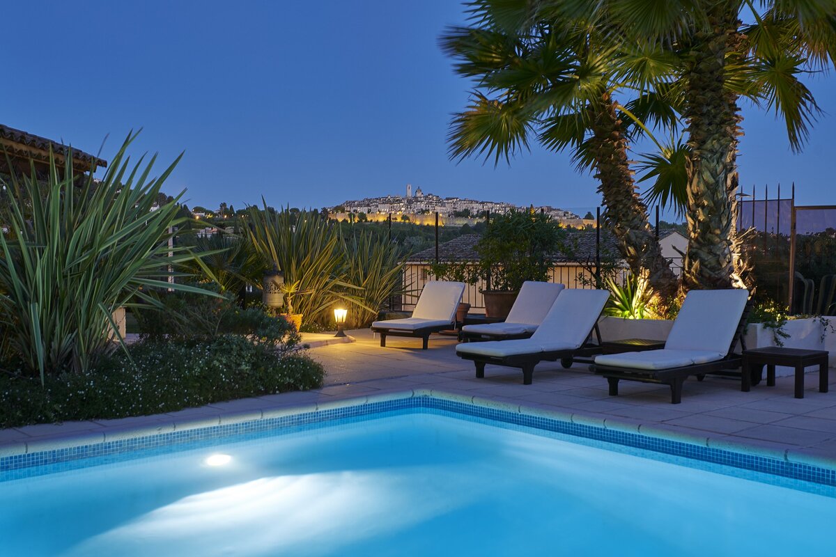 A swimming pool with a view of a city in the background