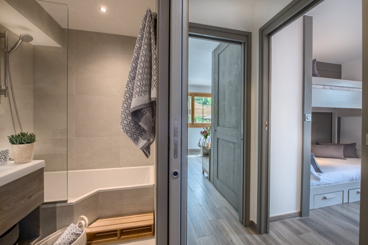 A bathroom with a bathtub and a bunk bed