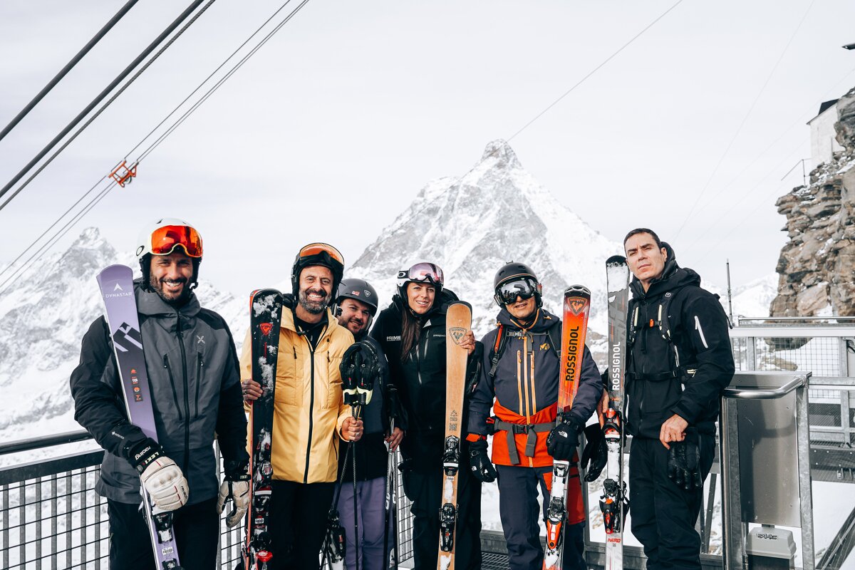 A group of people holding skis that say rossignol